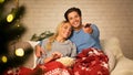 Cozy winter evening. Loving couple watching tv Royalty Free Stock Photo