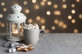 Cozy winter holiday background with gingerbread cookies on table, candles and a cup of coffee with marshmallows Royalty Free Stock Photo