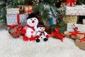 Cozy christmas background. Toy snowmen and presents under new year tree Royalty Free Stock Photo