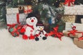 Cozy christmas background. Toy snowmen and presents under new ye Royalty Free Stock Photo