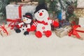 Cozy christmas background. Toy snowmen and presents under new ye Royalty Free Stock Photo