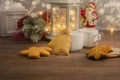 Cozy winter at home with hot drink and cookies. Christmas time with tea and garland Royalty Free Stock Photo