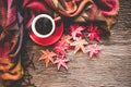 Cozy winter maple background, red cup of hot coffee with marshmallow, warm knitted sweater on old wooden background, Royalty Free Stock Photo