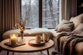 Cozy winter modern living room interior with a soft sofa by the window and cups of tea on the coffee table Royalty Free Stock Photo