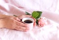 Cozy winter morning, breakfast in bed. Romantic background with a cup of coffee and red rose. Soft photo. Greeting card Royalty Free Stock Photo