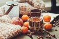 Cozy winter morning at home with fruits, nuts and candles, selective focus