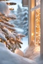 Cozy winter scene with lit christmas tree by a snowy window during twilight Royalty Free Stock Photo