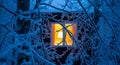 Cozy Winter Scene of Snow-Covered Window with Warm Lamp Glow Inside Royalty Free Stock Photo