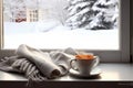 Cozy winter still life cup of hot coffee and opened book with warm plaid on vintage windowsill of cottage against snow landscape