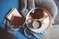 Cozy winter weekend at home. Morning with coffee or cocoa, berry pie, books, warm knitted blanket and nordic style chair. Hygge co Royalty Free Stock Photo