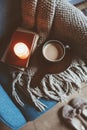 Cozy winter weekend at home. Morning with coffee or cocoa, books, warm knitted blanket and nordic style chair. Hygge concept. Royalty Free Stock Photo