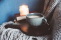 Cozy winter weekend at home. Morning with coffee or cocoa, books, warm knitted blanket and nordic style chair. Hygge concept. Royalty Free Stock Photo