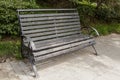 Wooden dark bench in a city park.