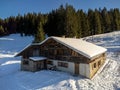 Cozy wooden chalet situated in the snow-covered Alps mountains of France.