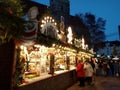 Cozy wooden houses covered with Christmas lights and a big christmas tree in the streets of Stuttgart