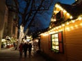 Cozy wooden houses covered with Christmas lights and a big christmas tree in the streets of Stuttgart