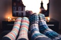 Cozy woolen socks. Couple watching tv in winter. Man and woman using online streaming service for movies and series.