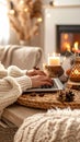 Cozy workspace with laptop, candle, and fireplace, winter vibes concept Royalty Free Stock Photo