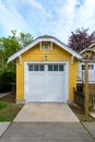 Cozy yellow garage with white doors