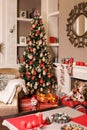 Cozyness and home comfort. Sofa near the decorated Christmas tree and fireplace with firewood. Winter holidays room interior, Chri