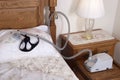 CPAP Sleep Apnea Machine Lying on Bed in Bedroom Royalty Free Stock Photo