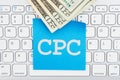 CPC with money on a keyboard with sticky note Royalty Free Stock Photo