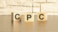 CPC text from wooden blocks on a gray stone background. Royalty Free Stock Photo