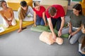 CPR class with caucasian instructors speaking and demonstrating help first aid Royalty Free Stock Photo