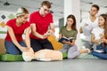 CPR class with caucasian instructors speaking and demonstrating help first aid Royalty Free Stock Photo