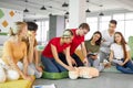 CPR class with caucasian instructors speaking and demonstrating help first aid Royalty Free Stock Photo