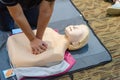 CPR First Aid Training with CPR dummy in the class. Demonstrating chest compressions concept Royalty Free Stock Photo