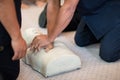 CPR training using and an AED and bag mask valve on an adult training manikin. Royalty Free Stock Photo