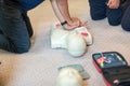 CPR training using and an AED and bag mask valve on an adult training manikin.