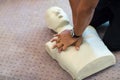 CPR training using and an AED and bag mask valve on an adult training manikin. Royalty Free Stock Photo