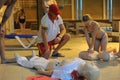 CPR training using and an AED and bag mask valve on an adult training manikin. First aid cardiopulmonary resuscitation course usin Royalty Free Stock Photo