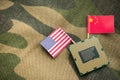 CPU computer (central processing unit) with US and Chinese flag on army cloth background. Royalty Free Stock Photo