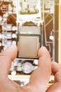CPU in hand before installation into the motherboard. Top view Royalty Free Stock Photo