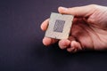 CPU processor chip computer on dark black background holding in hand Royalty Free Stock Photo