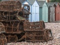 Crab creels and beach huts on the beach at Budleigh Salterton, East Devon, UK. Fishing and tourism, essential industries