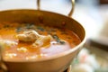 Crab curry with betel leaves in a brass pan at restaurant