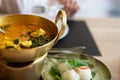 Crab curry with betel leaves in a brass pan at restaurant