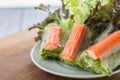 Crab stick in salad roll on white dish. Healthy food concept