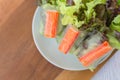 Crab stick in salad roll on white dish. Healthy food concept Royalty Free Stock Photo