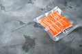 Crab stick surimi vacuum pack, on gray background , with copyspace and space for text