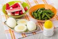 Crab sticks, green beans in bowls, boiled eggs in plate on napkin, salt on table Royalty Free Stock Photo