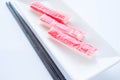 Crab sticks group with chopsticks on white background