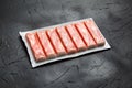 Crab sticks or imitation crab meat on black table Royalty Free Stock Photo
