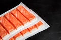 Crab sticks or imitation crab meat on black table Royalty Free Stock Photo