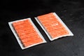 Crab sticks or imitation crab meat on black table Royalty Free Stock Photo