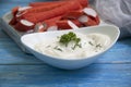 Crab sticks, sauce in a plate protein group delicious wooden background pr oduce